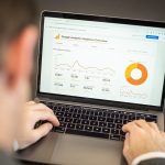 Marketer reviewing website analytics on a laptop